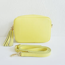 Lataa kuva Galleria-katseluun, ANGIE olkalaukussa on kaksi säädettävää olkahihnaa ja vetoketjukiinnitys. Tupsukoriste toimii vetimenä. Erittäin suosittu crossbody malli. Materiaali: aitoa nahkaa Väri: keltainen