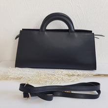 Lataa kuva Galleria-katseluun, ALIINA nahkalaukku kantokahvoilla ja säädettävällä olkahihnalla. Edestä laukkua koristaa kaunis kullanvärinen solkiyksityiskohta.