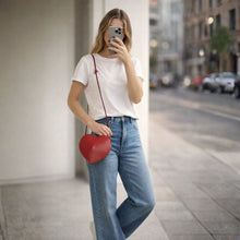 Lataa kuva Galleria-katseluun, SYDÄN on kompakti nahkalaukku, jonka selkeä sydämen muoto tekee siitä huomiota herättävän yksityiskohdan. Laadukas nahka ja viimeistelty muotoilu tuovat laukkuun ryhtiä ja kestävyyttä. Laukku sulkeutuu vetoketjulla. Sisällä on yksi tilava osio tärkeimmille tavaroille – puhelimelle, korteille ja muille pienille esineille. Pieni koko, selkeä ilme.