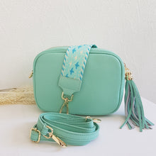 Lataa kuva Galleria-katseluun, ANGIE olkalaukku on aito nahkaa. Väri: minttu Koko: pituus 20 cm, korkeus 15 cm, syvyys 7 cm. Laukkuun kuulu kaksi säädettävää olkahihnaa: kapea nahkahihna kullanvärisillä pistolukoilla, leveys 2 cm, säädettävä pituus 130 cm leveä koristeellinen polyesteri/ nahka hihna kullanvärisillä pistolukoilla, leveys 5,5 cm, säädettävä pituus max. 128 cm Hoito-ohje: Voi suojata nahalle sopivalla suojausaineella ennen käyttöönottoa. Puhdistetaan kostealla liinalla. Valmistusmaa Italia.