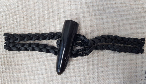 Tyylikäs musta duffelisolki, jossa on letitetty nahkajäljitemänauha ja polyesteri duffelinappi. Kummatkin puolet ovat noin 9 cm pitkät.